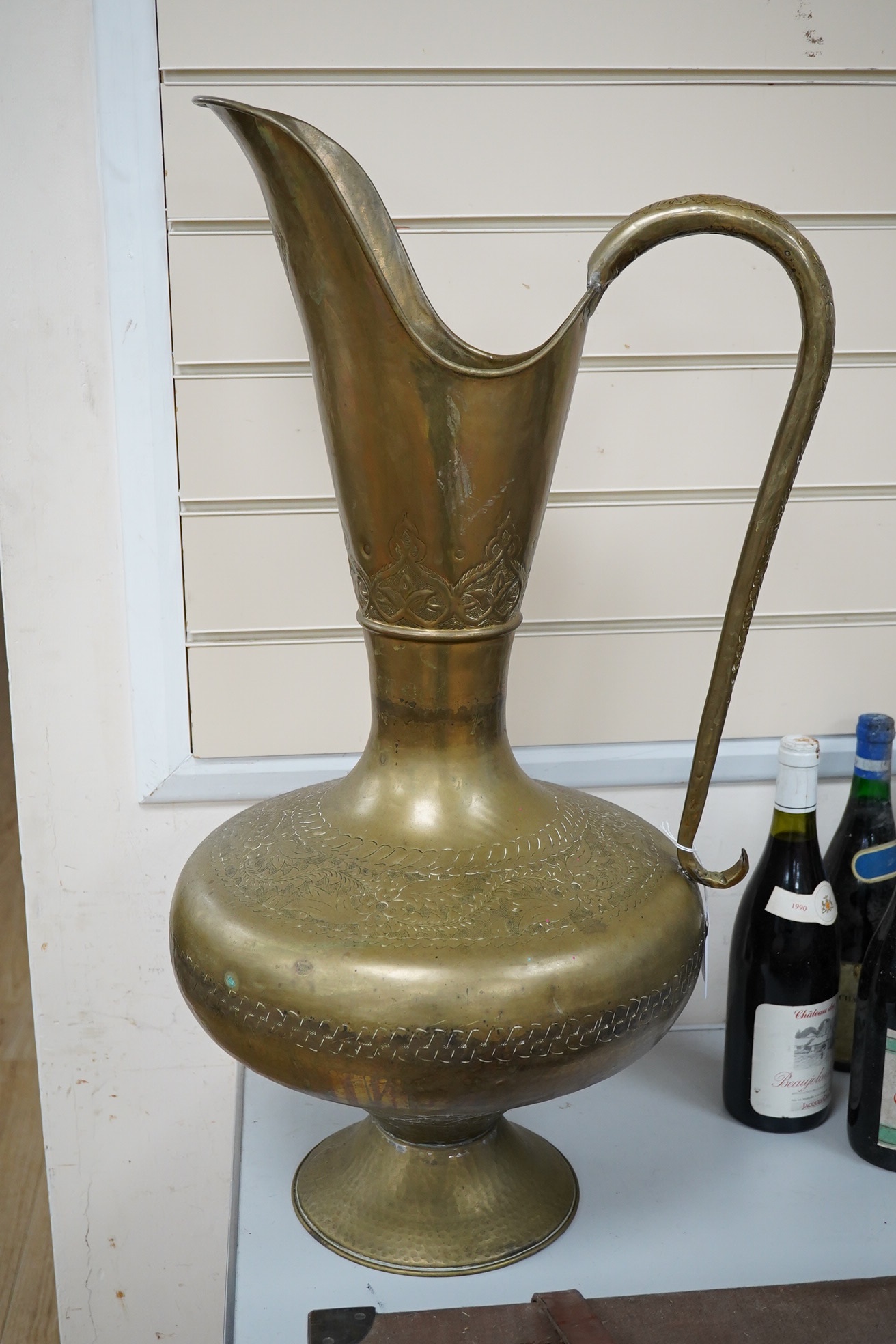 A large Indian brass ewer, 73cm tall. Condition - fair to good